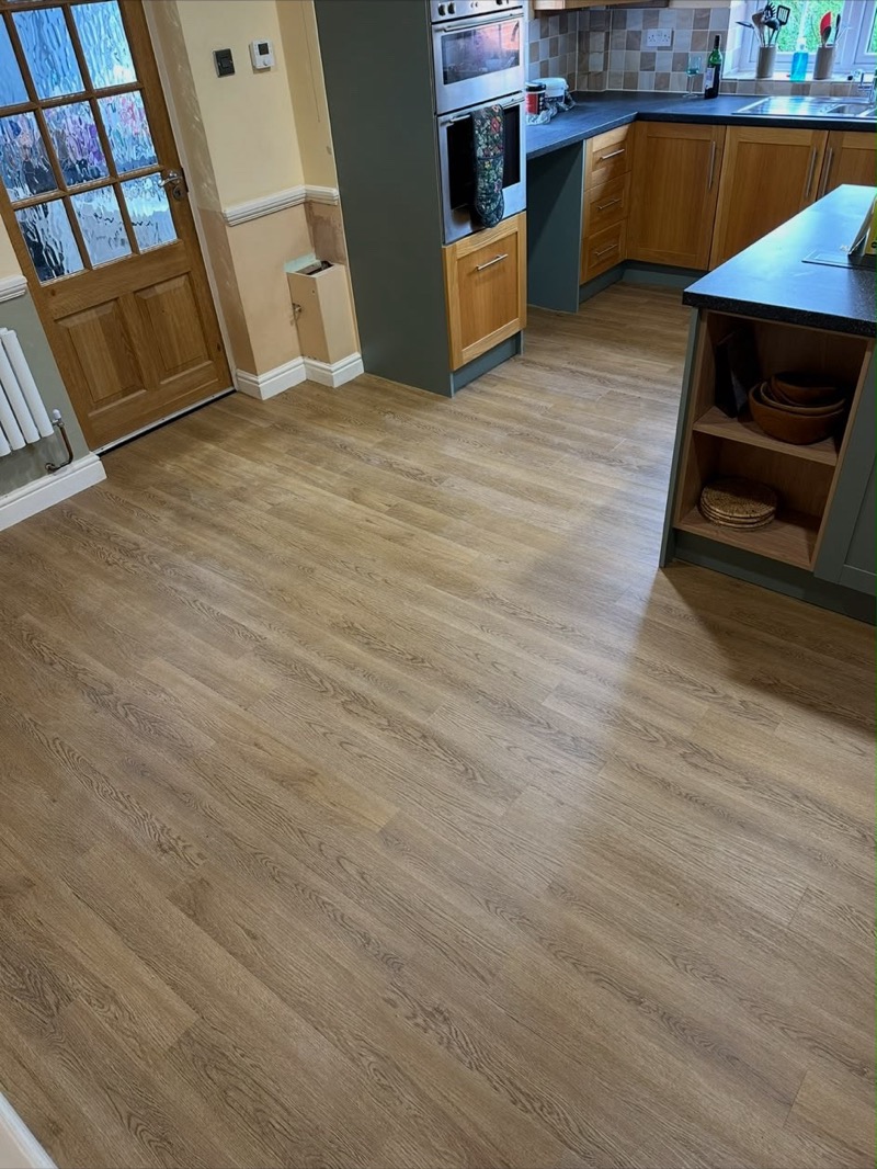 New luxury vinyl kitchen flooring in a light oak plank effect