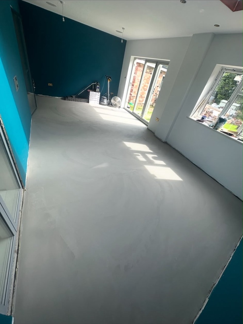 New grey kitchen flooring in a bright open-plan room