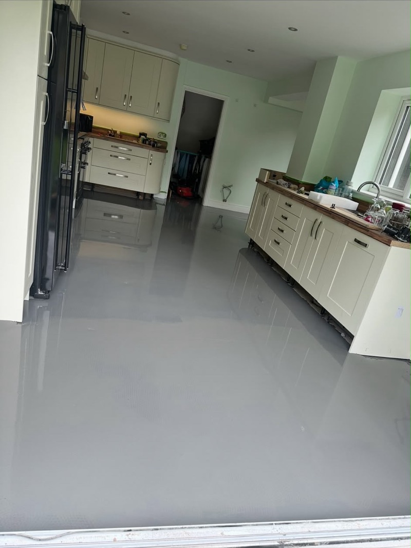 Grey wood-effect flooring in an open-plan kitchen